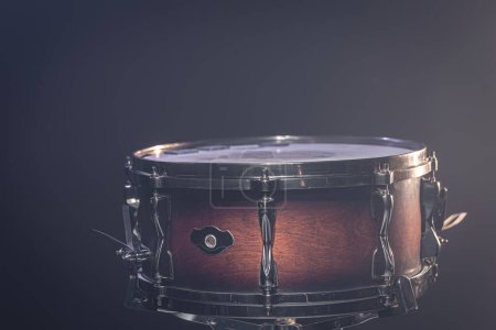 Photo for Close-up of a snare drum, percussion instrument on a dark background with beautiful lighting. - Royalty Free Image