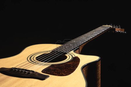 Close up of a classical light guitar on a black background, low key. Poster 652807402