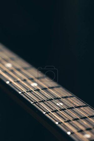 Photo for Close up, strings on acoustic guitar on blurred black background copy space. - Royalty Free Image