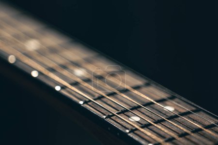 Foto de De cerca, cuerdas en la guitarra acústica en el espacio de copia de fondo negro borroso. - Imagen libre de derechos