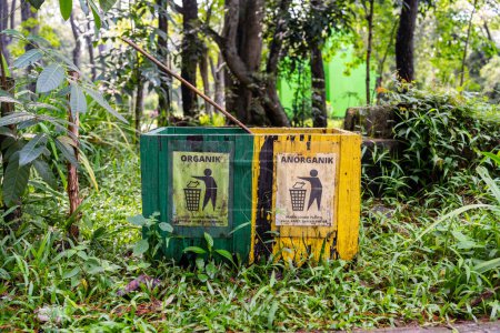 Palembang, Indonesia - February 21, 2024 : The trash cans in the Punti Kayu Natural Tourist Park are made of different colors, to differentiate between organic and inorganic waste.For recycled.