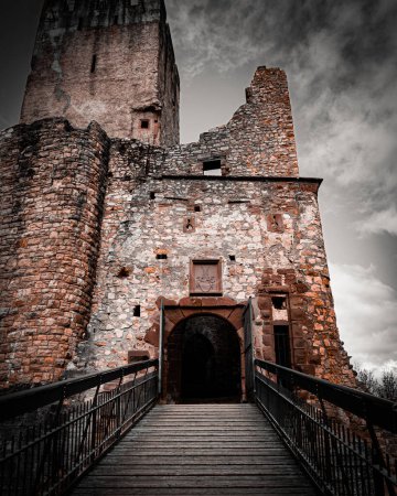 The ancient stone tower of a medieval castle stands tall against the sky.