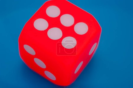 A dice showing six on blue background