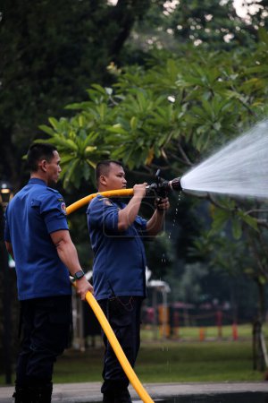 Photo for Jakarta, Indonesia. April 21, 2024. At TMII, Jakarta, firefighters work to extinguish a fire on an Ogoh-ogoh - Royalty Free Image