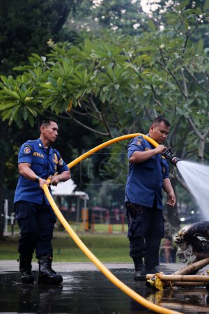 Photo for Jakarta, Indonesia. April 21, 2024. At TMII, Jakarta, firefighters work to extinguish a fire on an Ogoh-ogoh - Royalty Free Image
