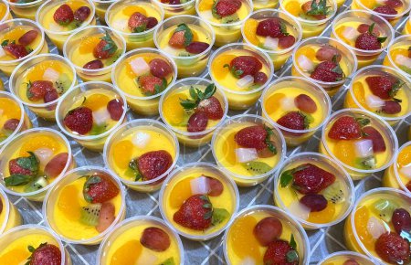 Catering - Home Industry - Production of healthy mango milk pudding. Puddings are made from mango juice and milk. Topping: vanilla jelly, strawberry, grape, kiwi, mandarin orange, and nata de coco (coconut gel)
