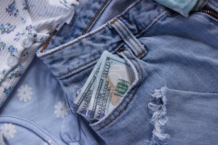 Photo for Blue jeans with American dollars in the pocket, top view. Concept of traveling or shopping - Royalty Free Image