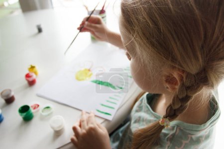 Photo for Little child draws with watercolor, concept of education in the kindergarten, soft focus background - Royalty Free Image