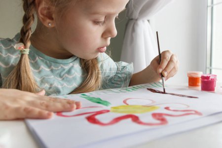 Photo for Little child draws with watercolor, concept of education in the kindergarten, soft focus background - Royalty Free Image