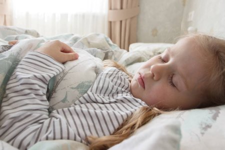 Photo for Little cute girl lying in the bed. Concept of rest at home - Royalty Free Image