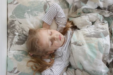 Photo for Little cute girl lying in the bed. Concept of rest at home - Royalty Free Image