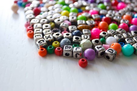 Photo for Background from different colored beads with numbers and symbols, top view - Royalty Free Image
