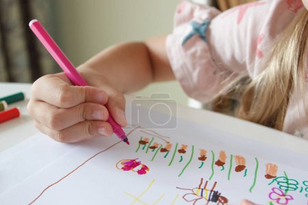 Photo for Cute child drawing a picture with colored felt-tip pens. Concept of hobby and education - Royalty Free Image