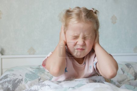 Photo for Little cute child closing ears with hands. The fear of loud sounds ?oncept or depression - Royalty Free Image