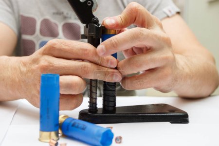 A man make repairing of plastic case for making a cartridges for shooting or hunting
