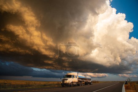 Truck Passing Under Building Storm Clouds Full Of Sun Set Colour