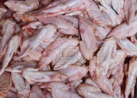raw chicken wings tip closeup. pile of raw chicken wings wastage in market.fresh and clean chicken wing parts.