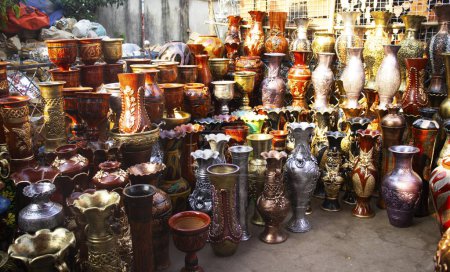 Bright colorful handicraft,earthenware pottery, terracotta pots, flower vase display on village fair.Artistic painted colorful handcrafted Products selling in handicraft fair.