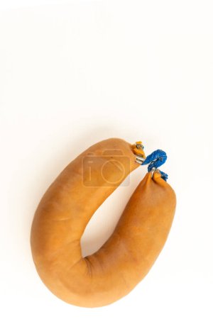 A farinheira is a Portuguese sausage made of pork fat, flour, paprika, and garlic. This stock photo shows a single farinheira on a white background, emphasizing its distinct color and texture.