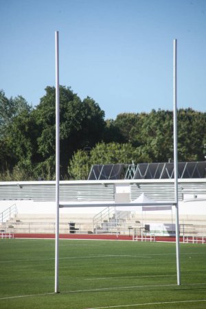 Rugby goal post against clear sky backdrop. Iconic sports equipment for dynamic action shots.