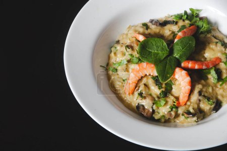 Delicious shrimp risotto, a savory Italian dish made with Arborio rice, seafood broth, and flavorful herbs, garnished with plump shrimp.