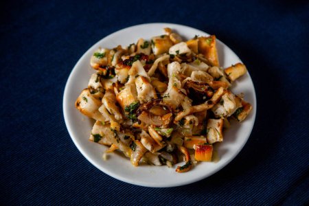 Grilled Portuguese cuttlefish strips, a savory traditional snack.