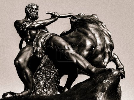 Photo for A monochrome photograph capturing a sculpture of a man riding a bull, showcasing the creative artistry and intricate metal work of the monument - Royalty Free Image