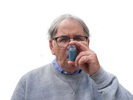 Senior Man Using Asthma Inhaler For Allergies