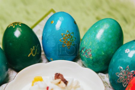  Indulge in the joyous traditions of Orthodox Easter with a delightful array of whimsically colored marbled eggs against a backdrop of lush greenery, radiating warmth and holiday cheer.
