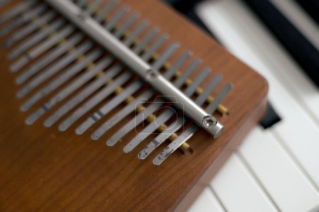 Close-up of a kalimba musical instrument made of brown wood. 