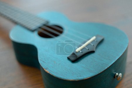 Photo for Close-up of a ukulele made of turquoise wood. - Royalty Free Image