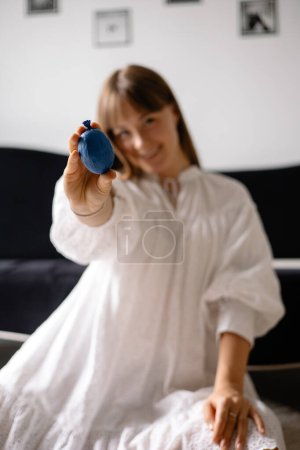 Photo for A ball with filler for the development of fine motor skills of childrens hands in hands of a female teacher, blurred background - Royalty Free Image