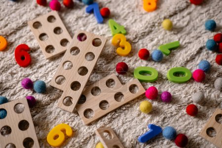 Photo for Background of multi-colored wooden numbers and numicon to teach children to count - Royalty Free Image