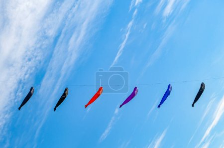 Various colorful kites flying in the blue sky. High quality photo