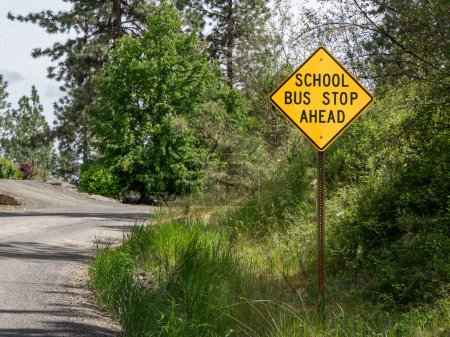 Outdoor "School Bus Stop Ahead" sign, located in the Pacific Northwest. Cheney, Washington