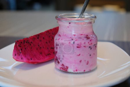 Red dragon fruit smoothies in glasses and on wood table. High quality photo