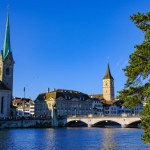 view from the bank of the Limmat river in Zurich to the old bridge and towers