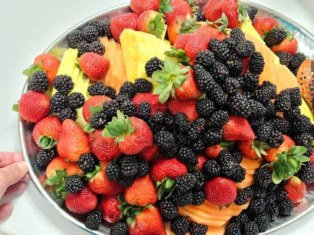 Overhead food flat lay fresh fruit tray for party.
