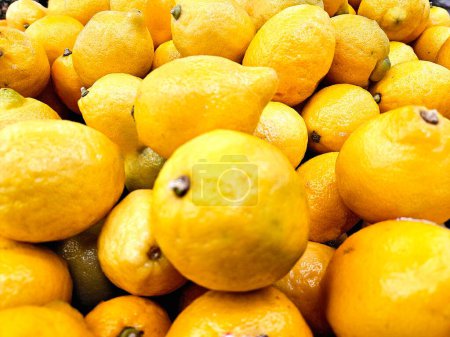 Overhead food flat lay yellow lemons in grocery display. 