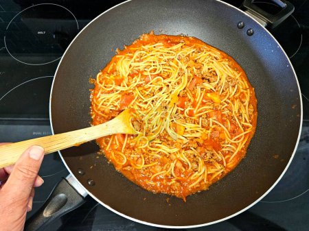 Overhead food flat lay spaghetti cooked in a wok.