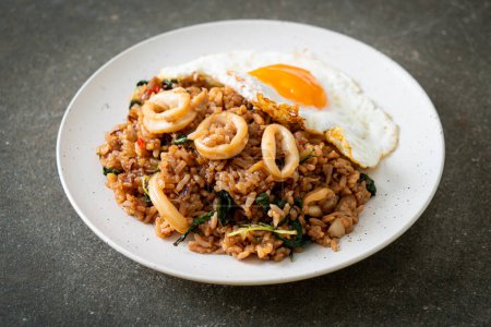 Photo for Fried rice with squid and basil topped fried egg in Thai style - Asian food style - Royalty Free Image