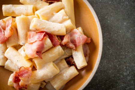 Photo for Homemade spaghetti rigatoni pasta with white sauce and bacon - Italian food style - Royalty Free Image