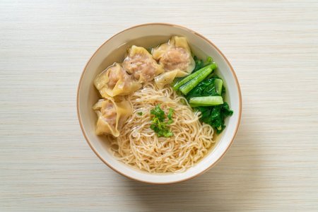Photo for Egg noodles with pork wonton soup or pork dumplings soup and vegetable - Asian food style - Royalty Free Image