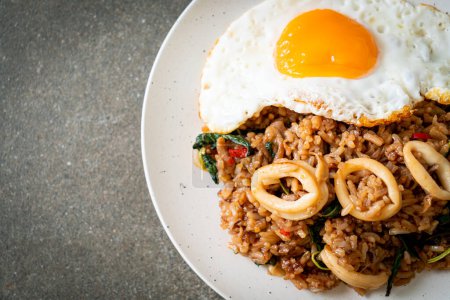 Photo for Fried rice with squid and basil topped fried egg in Thai style - Asian food style - Royalty Free Image