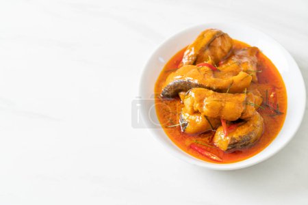 Photo for Redtail Catfish Fish in Dried Red Curry Sauce that called Choo Chee or a king of curry cooked with fish served with a spicy sauce - Royalty Free Image