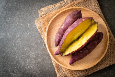 Photo for Grilled or baked Japanese sweet potatoes on wood plate - Japanese food style - Royalty Free Image