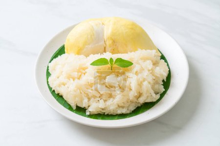 Photo for Durian with sticky rice -  sweet durian peel with yellow bean, Ripe durian rice cooked with coconut milk - Asian Thai dessert summer tropical fruit food - Royalty Free Image