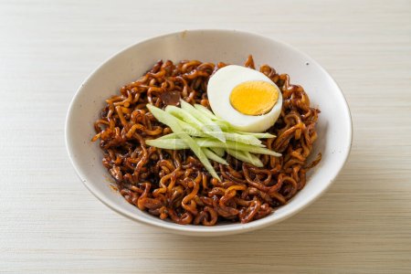 Korean Instant Noodle with Black Bean Sauce topped cucumber and boiled egg (Jajangmyeon or JJajangmyeon) - Korean food style