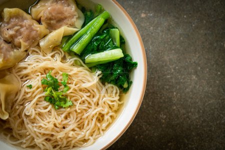 egg noodles with pork wonton soup or pork dumplings soup and vegetable - Asian food style