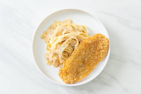 homemade fettuccine pasta white cream sauce with fried fish